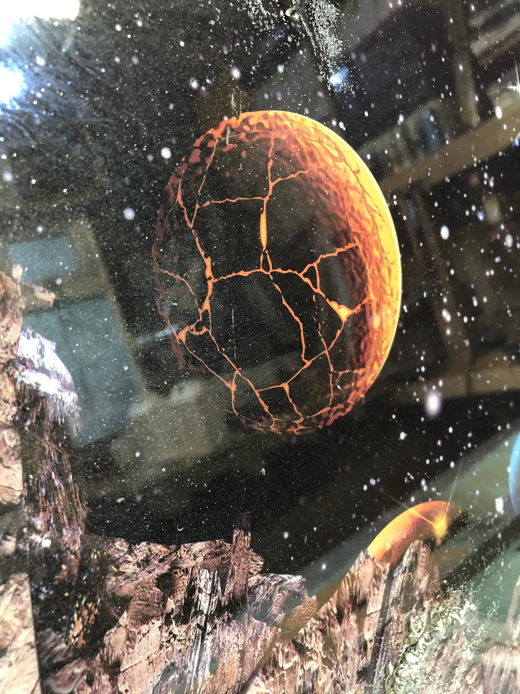 Macro detail of a cracked orange planet within the scene