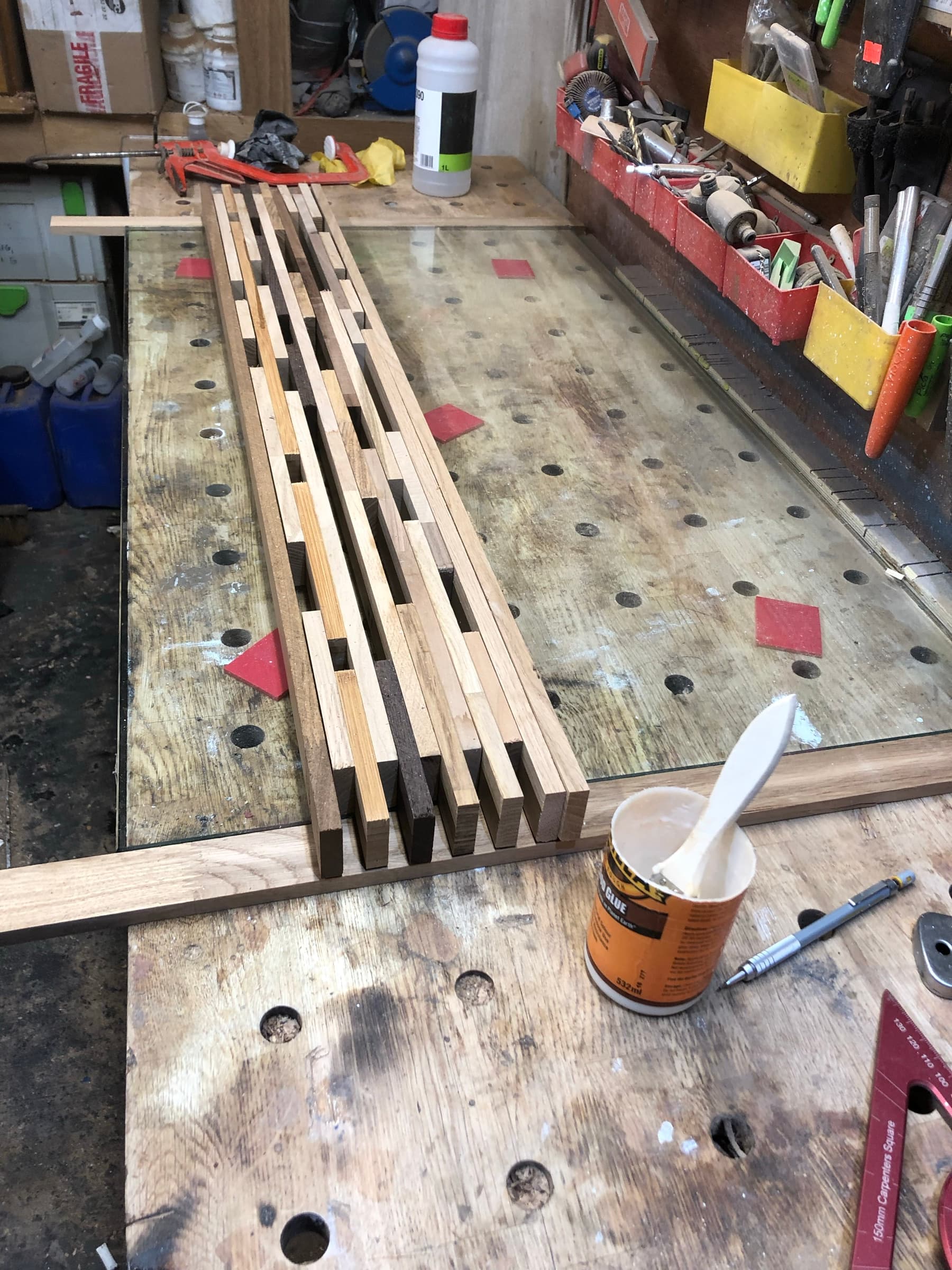 Individual timber strips glued and clamped together in the workshop, before cutting to length