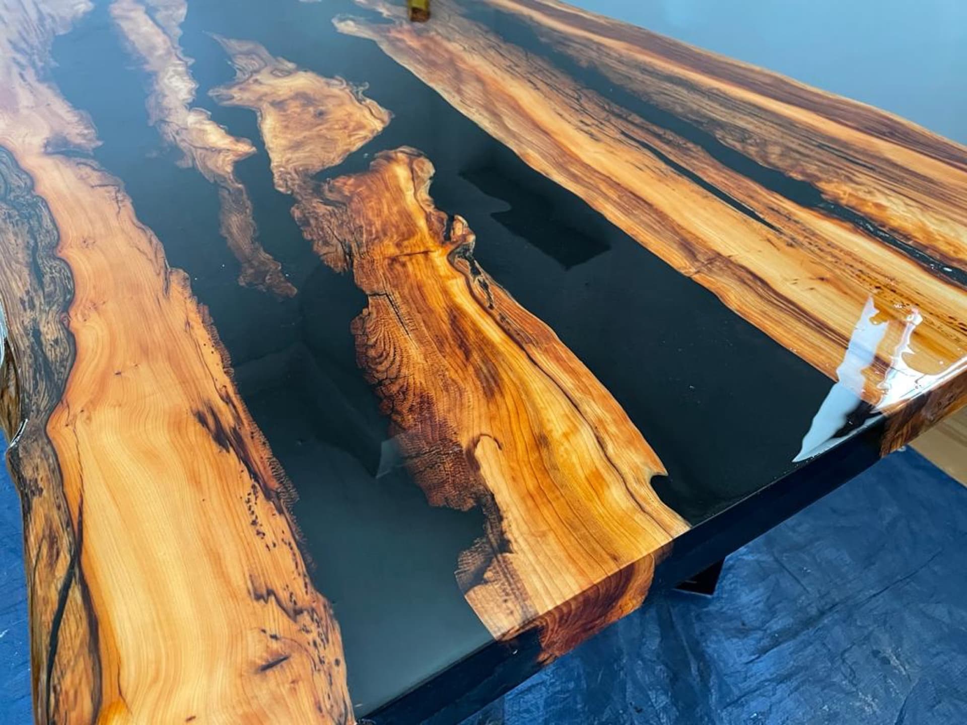 Close top-down detail of the tiger-striped yew grain against glossy black resin
