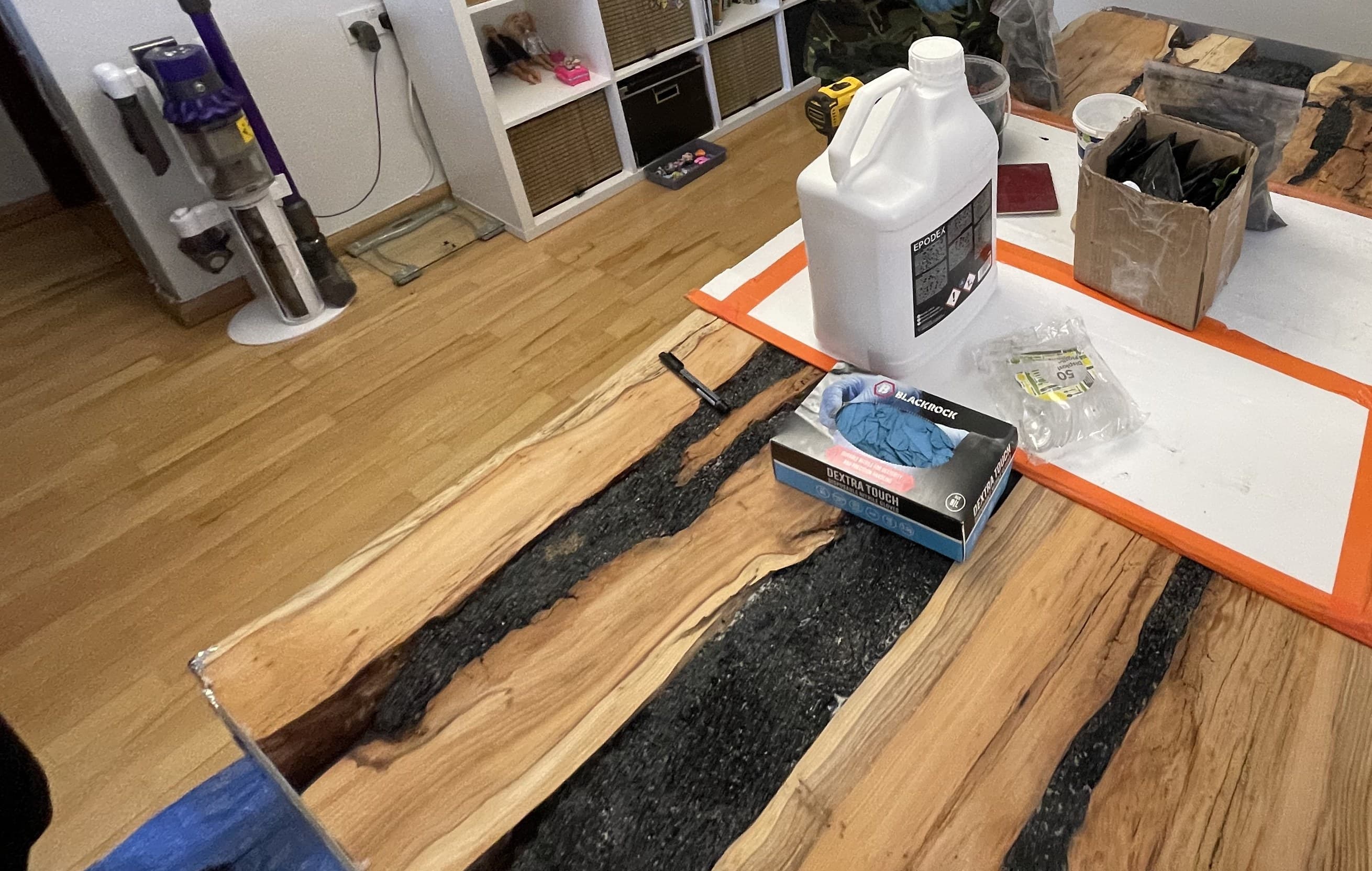 Casting resin and workshop materials laid out beside the slab mid-build