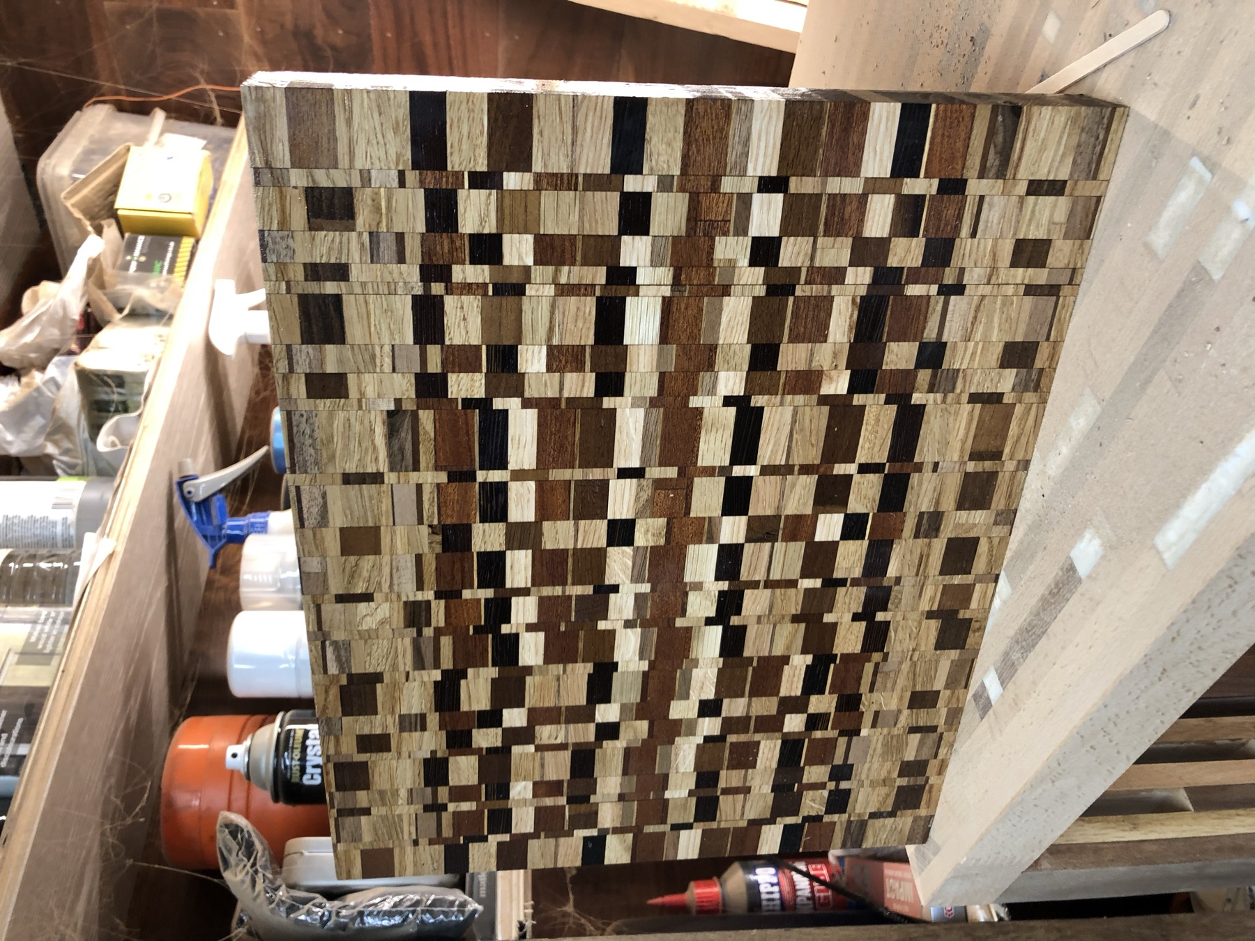 End-grain checkerboard-weave board leaning in the workshop