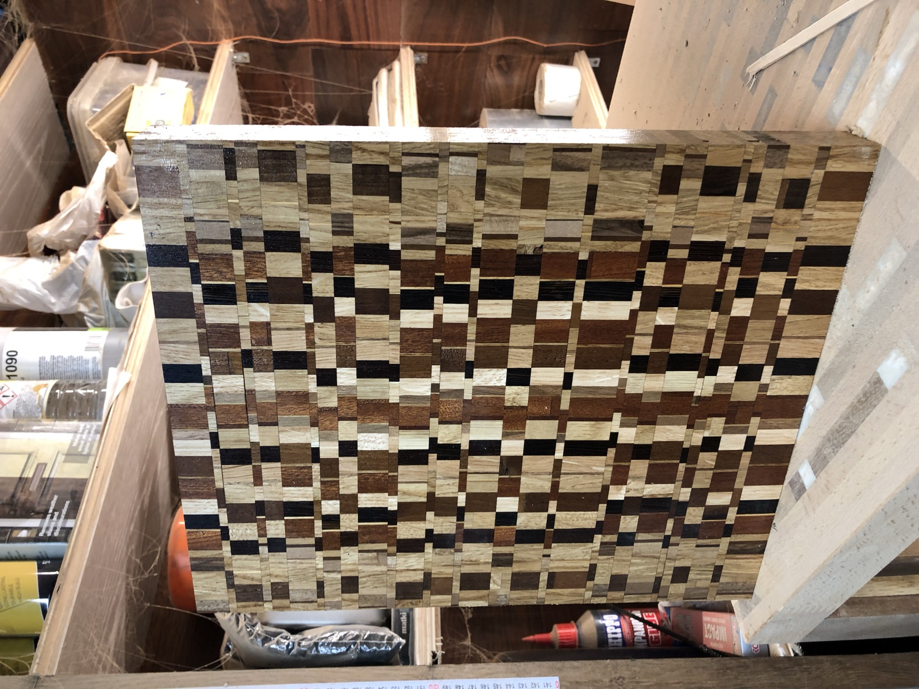 End-grain checkerboard-weave board, workshop shelving behind