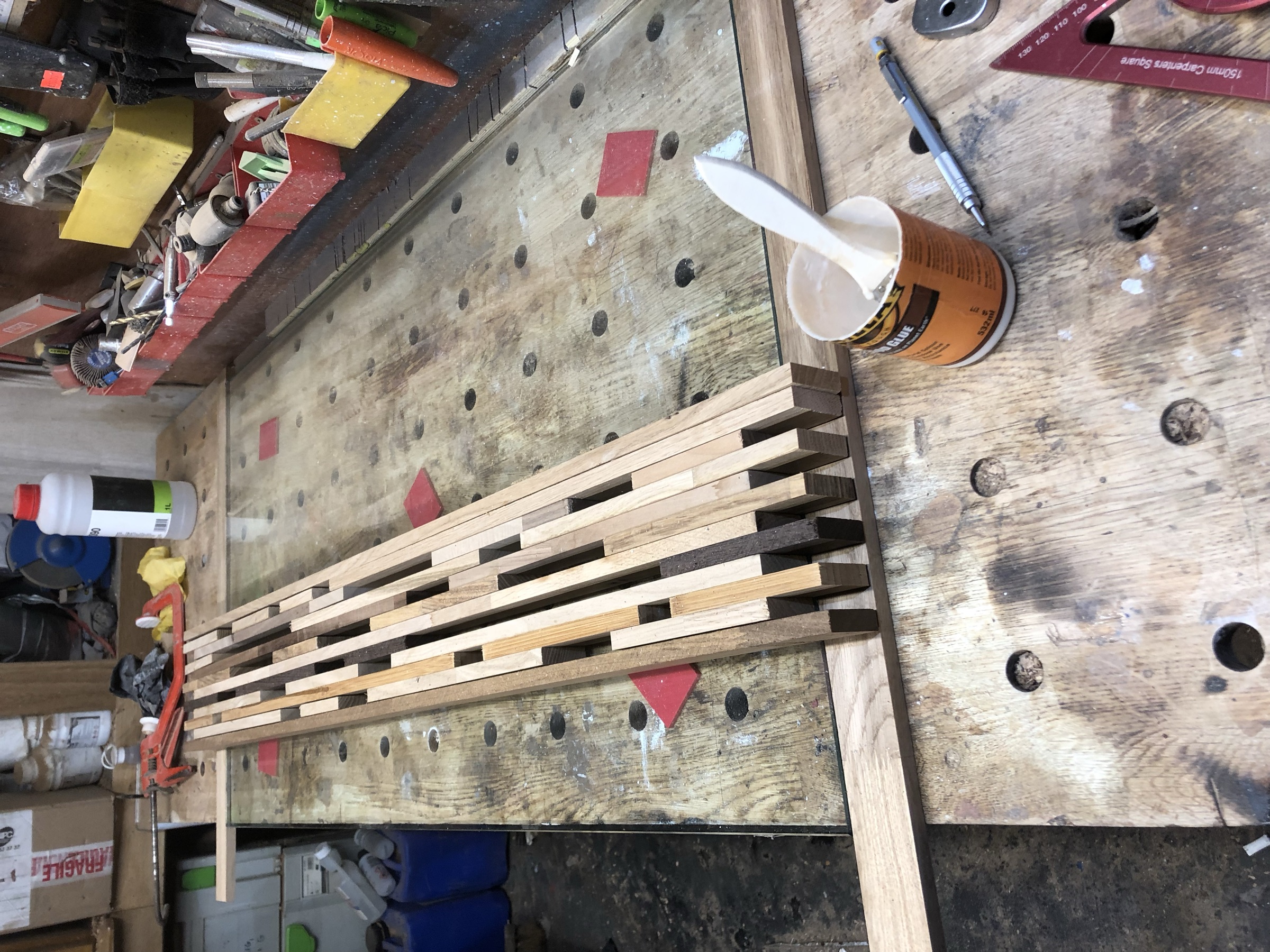 Individual timber strips glued and clamped together in the workshop, before cutting to length