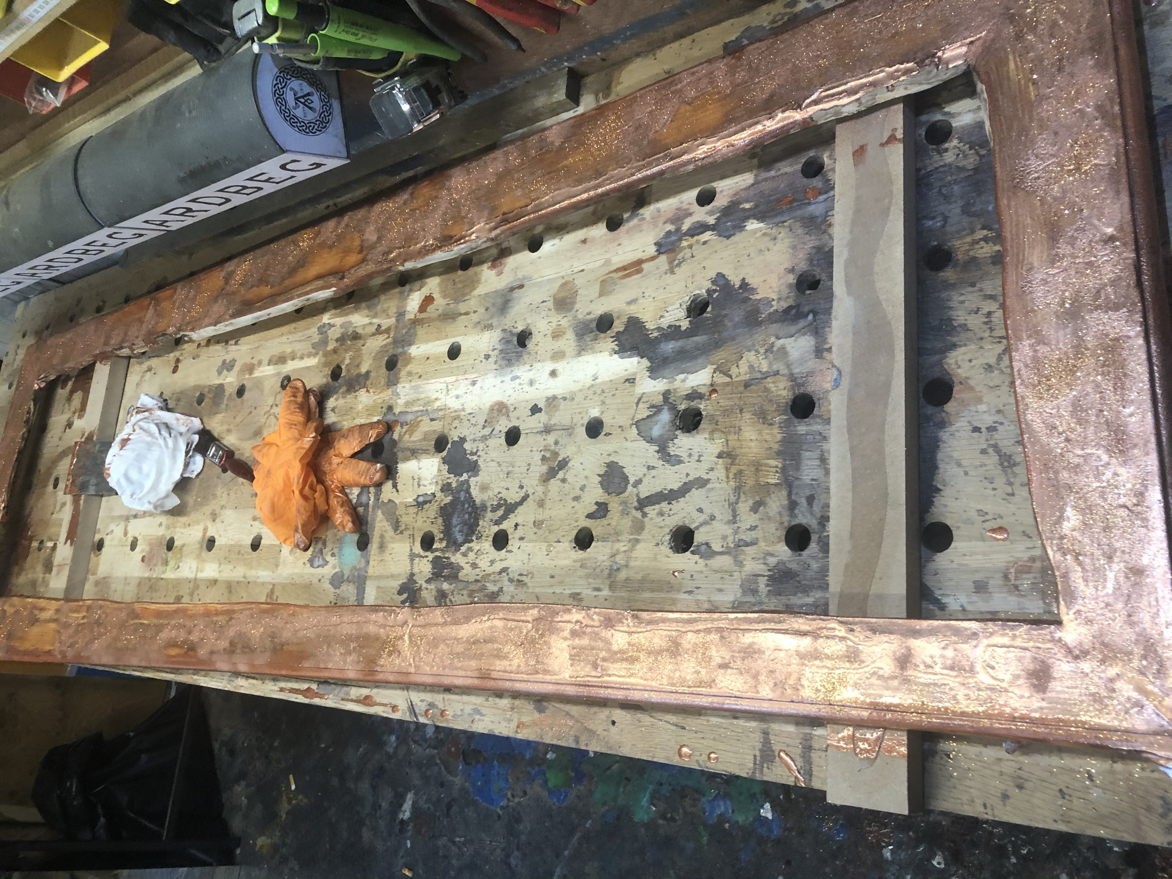 The frame laid flat mid-construction on the workbench, before assembly